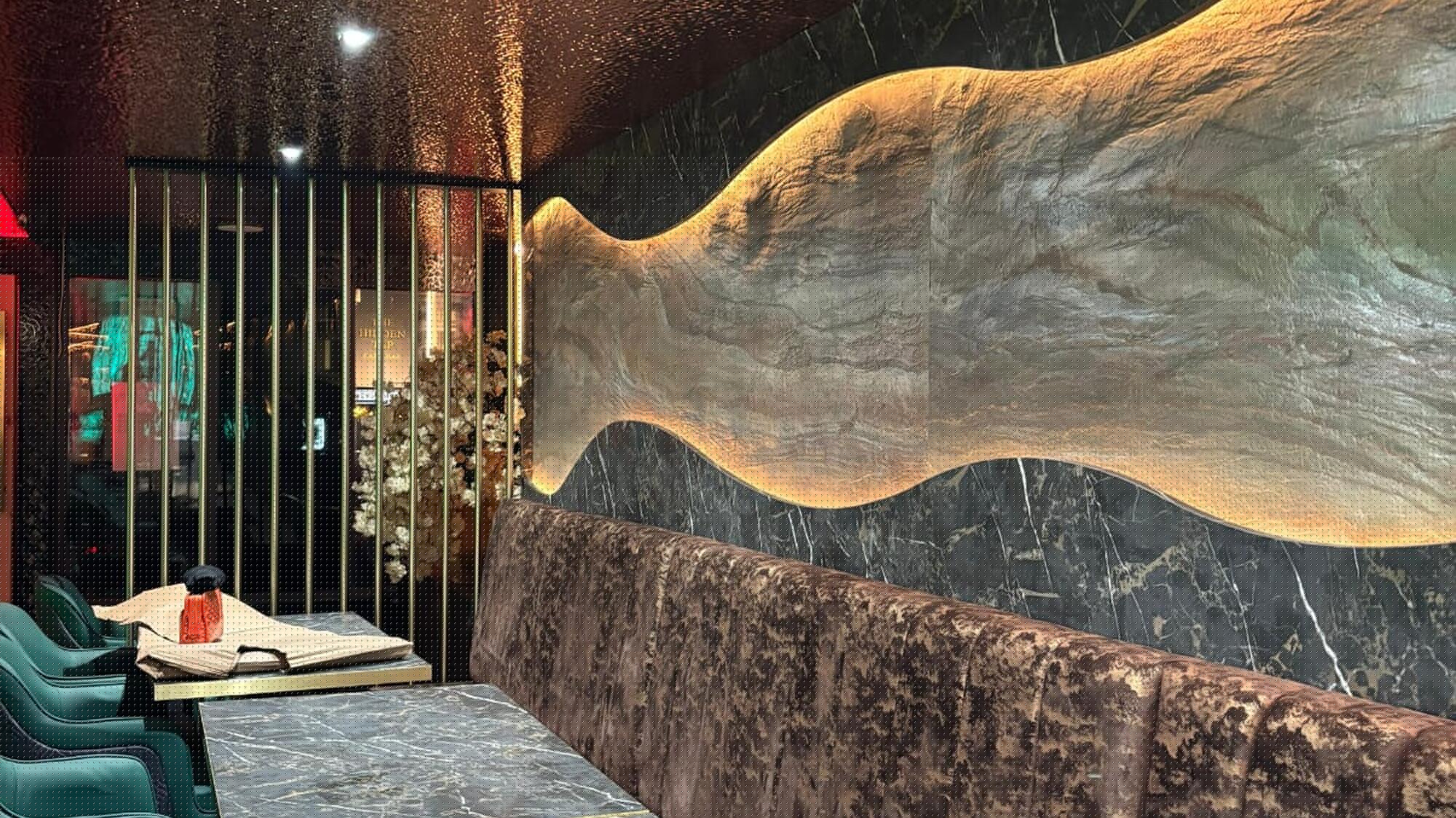 Curved stone feature wall behind booth seating