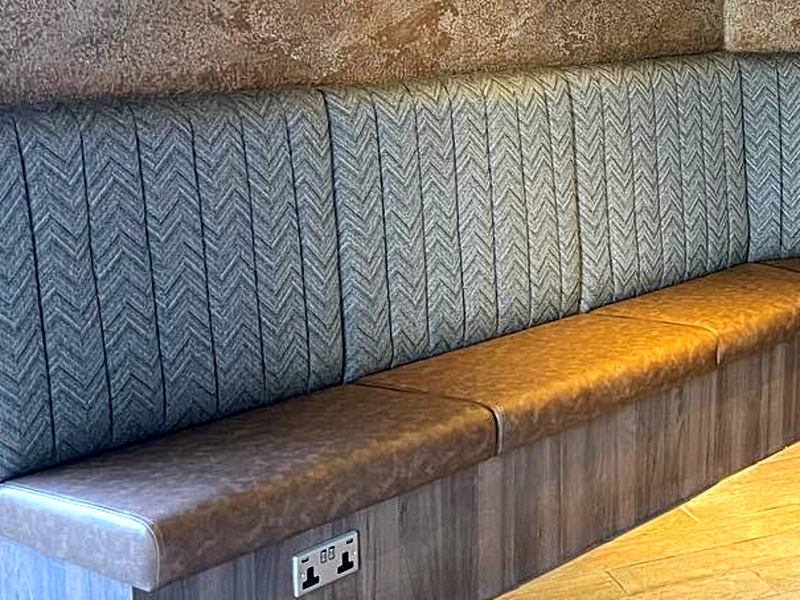 Fixed banquette seating run with leather seat pads
