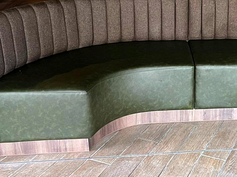 Fluted curved booth seating in green leather