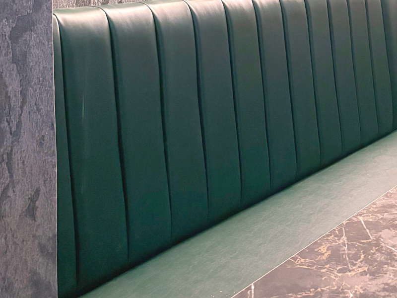 Fluted green leather banquette seating