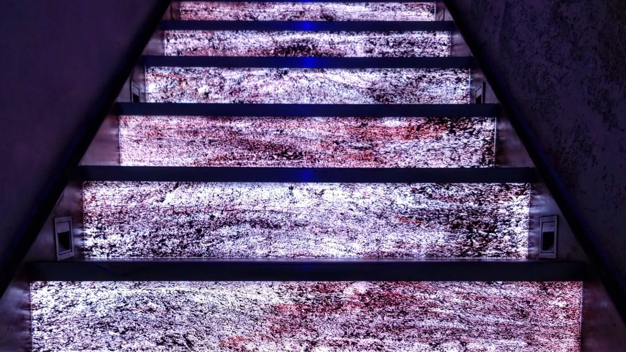 Illuminated stone staircase with purple lighting