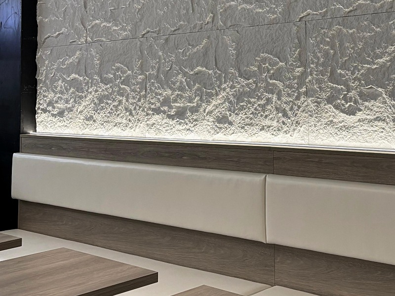 White leather wall mounted banquette seating